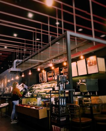 Warm and inviting café interior with modern lighting and seating. Perfect for a relaxing coffee break.